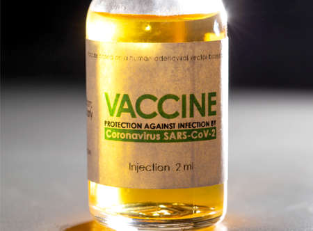 Vial with coronavirus vaccine on a black background, close-up. Vaccine development and research...