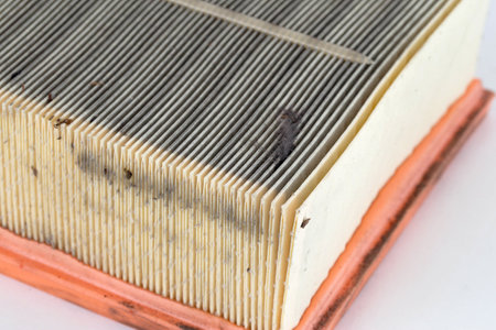 Dirty car air filter texture and background. Air filter element in a car engine, macro