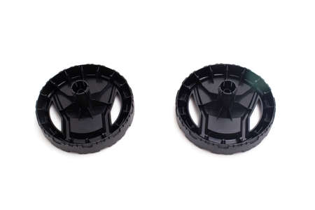 Black plastic wheels from a pressure washer on a white background, isolate. close-up, automotive