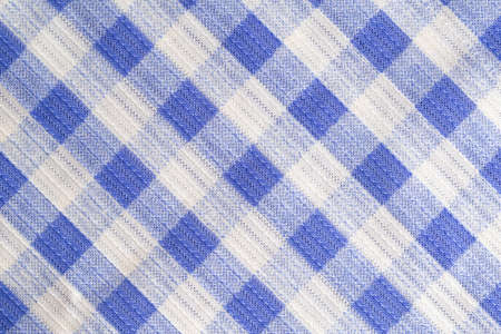 Blue kitchen material in a cage, tablecloth on the table, background. Macro, textured