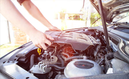 Mechanical starts repairing modern diesel car engine, background. Industry