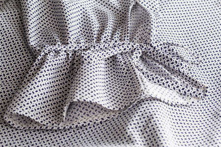 Variegated beautiful fabric from a blouse, lace tying a sleeve, close-up, quality