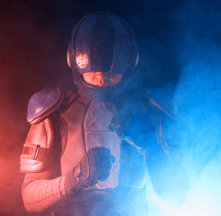 Male robot cop waves and punches his fits in dark. Halfman is ready to fight. Bionic cyborg looks at...