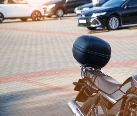 Black trunk on a motorcycle tourist in the city, motorcycle tourism conceptの写真素材