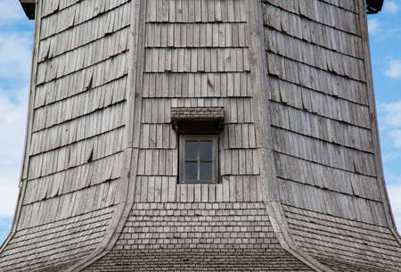 Antique window in a wooden planked wall, close-upの写真素材