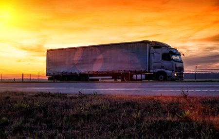 A beautiful truck with a trailer against the backdrop of an evening sunset before night. The concept...