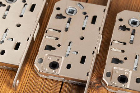 Door latch plumbing magnetic on a wooden background. door furniture