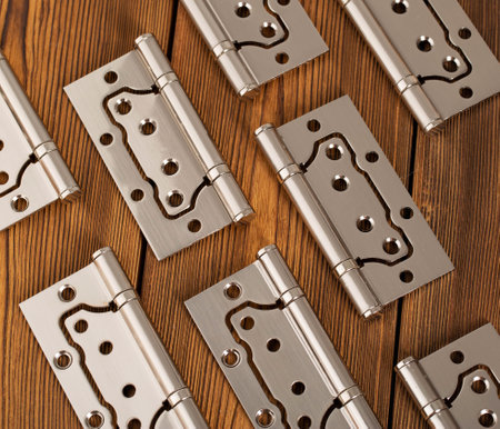 door metal hinges on a wooden background, macro. Door furniture, chromeの写真素材
