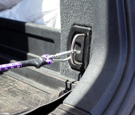 latch in the trunk of the car for securing goods and objects