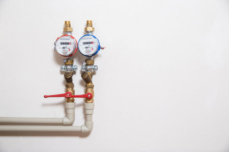 Plumbing water meters on a white wall. The concept of payment for water, accounting for water...