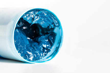 Tube with blue automotive high temperature grease on a white background, isolate. Copy space for...