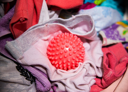 Red ball for washing clothes in the washing machine. Improving the quality of washingの写真素材