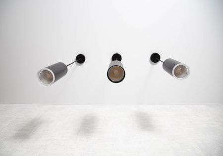 three modern LED lights hang from the ceiling on a wire, illumination