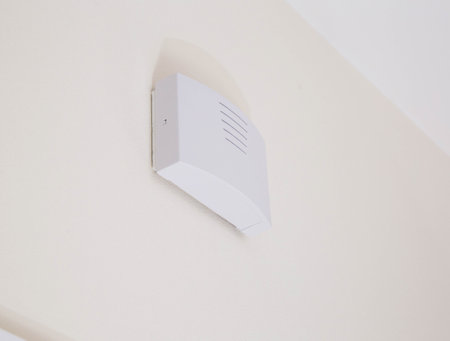 Modern electric doorbell in the apartment on the wall, white