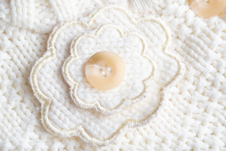 Comfortable warm knitted sweater made of white threads, background. Macro, handmade