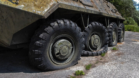 Wheels of armored personnel carriers pierced by bullets during a military battle. Military conflict and weapons. Equipment damage, puncturedの写真素材