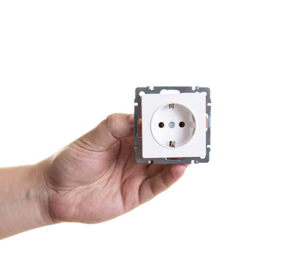A man holds a socket in his hand on a white background, close-up. Isolate