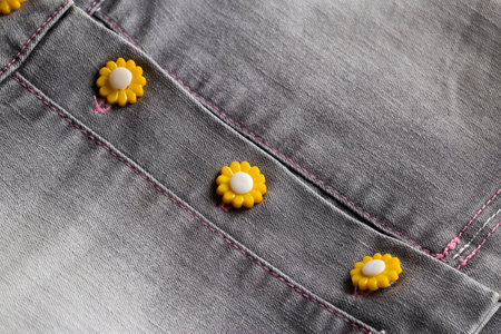 Stylish buttons on a trendy denim skirt, background, macro. Textile