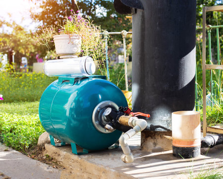 Water supply system from a well in a country house. New water filter. Hydraulic accumulator for storing water volume. Industryの写真素材
