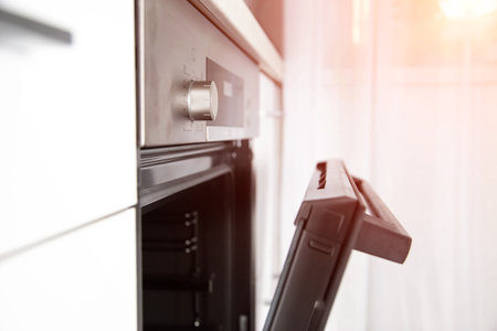 Modern electric oven with hinged door, clock and cooking timer function.の写真素材