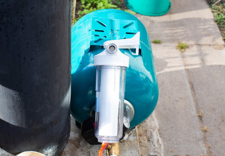 The system of modern water supply in a country house from a well source. Hydraulic accumulator for...