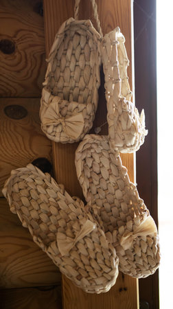 Bast shoes woven from the bark hang. Handmade, old shoes, traditional.の写真素材