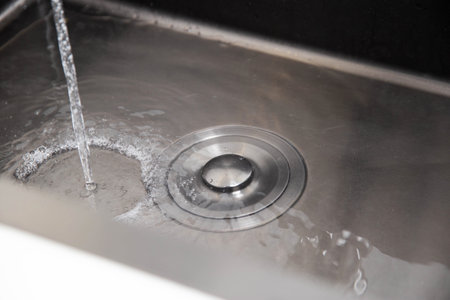 Modern stainless steel sink with plug for draining water and filling the water level.の写真素材