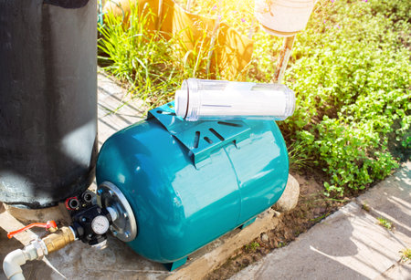 Water supply system from a well in a country house. New water filter. Hydraulic accumulator for storing water volume. Industryの写真素材