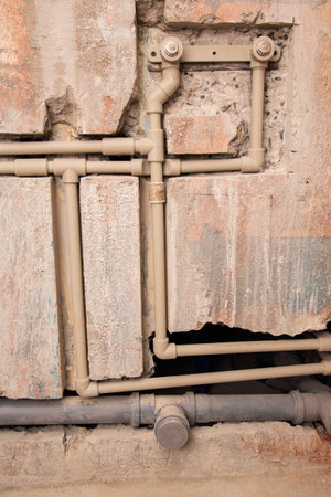 Transfer of water pipes and sewerage drain in the wall. Bathroom plumbing installation.