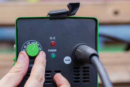 Adjusting the current strength on a modern welding machine. Welding arc.