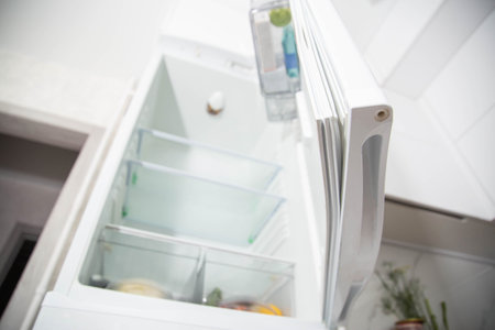 Torn and damaged sealing gum on the refrigerator door. Replacing the old sealing rubber with a new one, close-upの写真素材