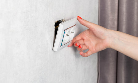 The girl is trying to insert a torn out socket from the socket due to the wrong pulling out of the...