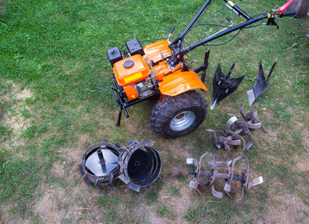 Agricultural walk-behind tractor with a set of attachments, hiller, milling cutters and lugs.の写真素材