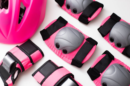 Pink helmet, knee and hand protection. Concept set of protection for roller skating, cycling and scooter.の写真素材
