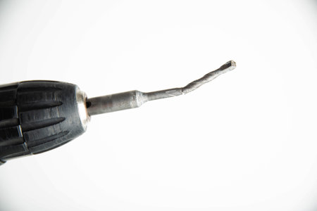 Poor quality broken metal drill on a white backgroundの写真素材