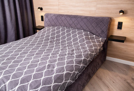 Modern bedroom interior with bed and headboard lamps, decoration