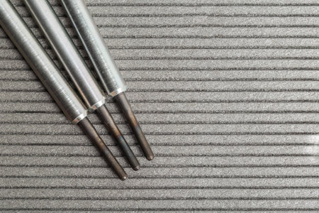 Modern rod ceramic glow plugs for easier starting of a diesel engine in cold weather on a gray background. Automotive spare part, heating element, engine preheaterの写真素材