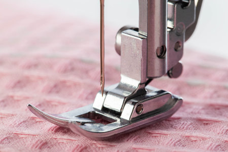 Sewing machine foot and needle plate with needle holder. Macro, industry. Copy space for textの写真素材