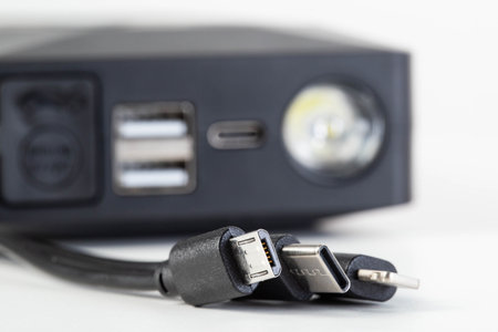 Connectors for charging a phone micro-usb, lightning, usb, type-c on the background of a power bank...