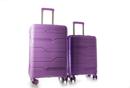 Set of polypropylene purple suitcases on a white background, isolateの写真素材