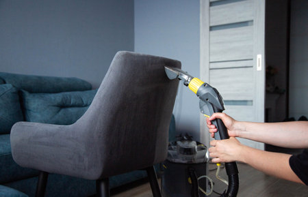 Dry cleaning services, washing and cleaning gray fabric chairs with a washing vacuum cleaner. Copy space for textの写真素材