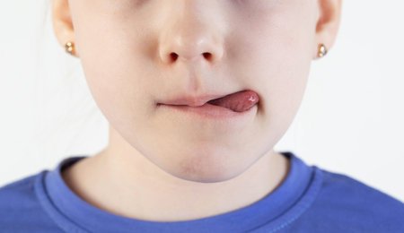 Child girl mouth with tongue. The concept of appetite in children, burring and failure to pronounce words, plasticity of the frenulum of the tongue.の写真素材