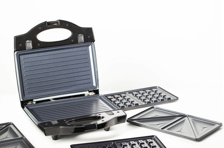 Sandwich maker with baking dishes on a white background, isolate, close-up, technologyの写真素材