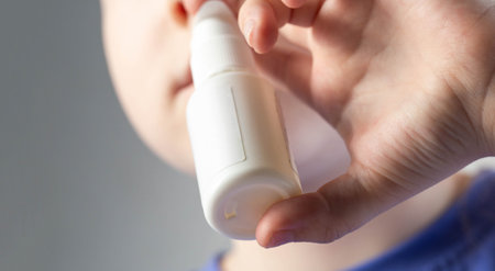 A caucasian girl puts drops into her nose and an anti-inflammatory spray for nasal congestion. Treatment of runny nose and sinusitis. Antibiotic medicinal spray.の写真素材