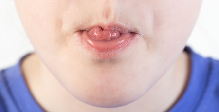 The mouth of a child that shows his tongue.の写真素材