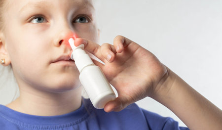 A caucasian girl puts drops into her nose and an anti-inflammatory spray for nasal congestion. Treatment of runny nose and sinusitis. Antibiotic medicinal spray.の写真素材