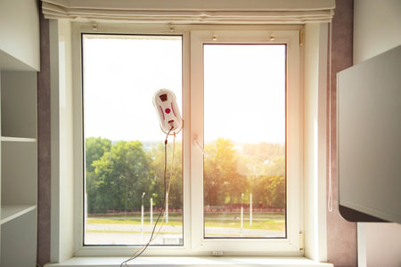 A modern device, a vacuum robot window cleaner, cleans glass from dirt and streaks with safety from falls from a height.の写真素材