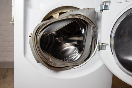 An old torn rubber seal for the sunroof with a defect, in the washing machine. Replacement of faulty spare parts, close-upの写真素材