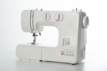 Automatic modern sewing machine with overlock on a white background, isolate. Studio concept.の写真素材
