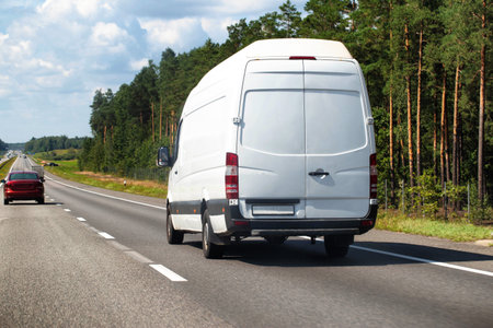 White cargo minibus transports household products, high delivery speed and low cost. Copy space for textの写真素材
